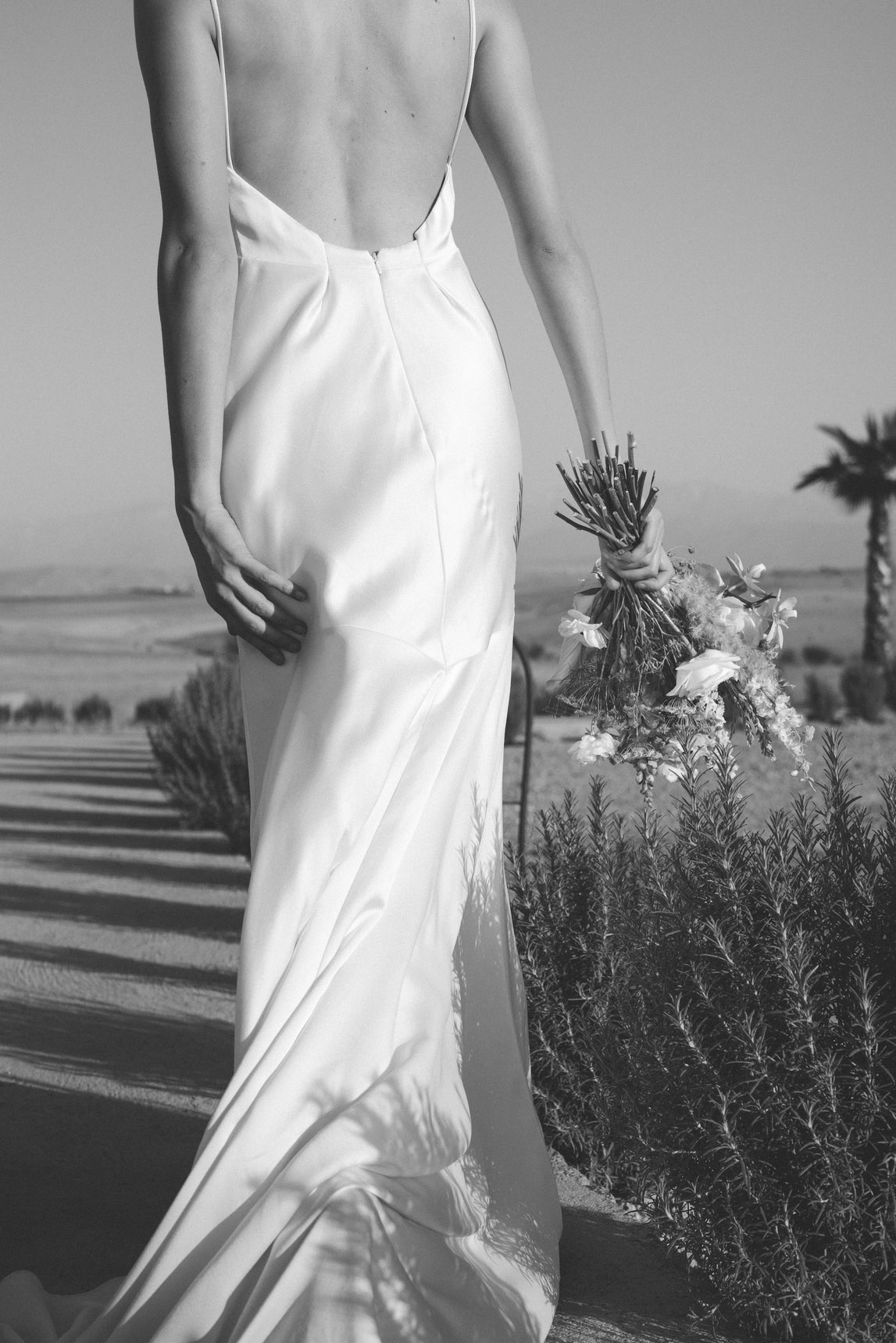 détail du dos de la robe de la mariée et de son bouquet de fleurs de mariée