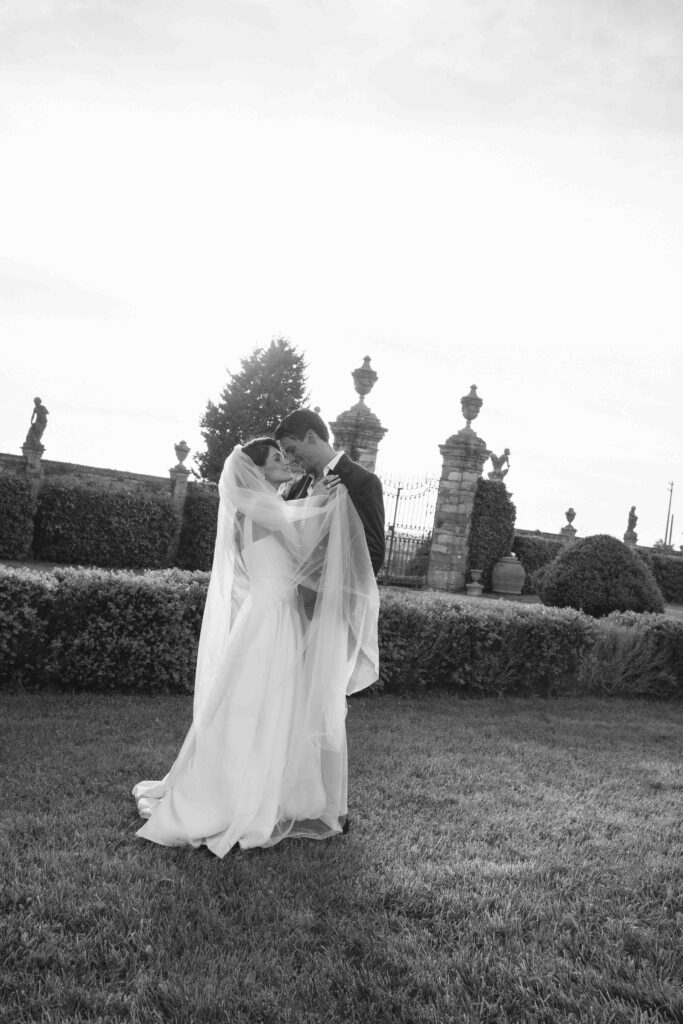 wedding in italy, a couple in a Tuscany villa during their couple photo shoot with ancient architecture in backdrop