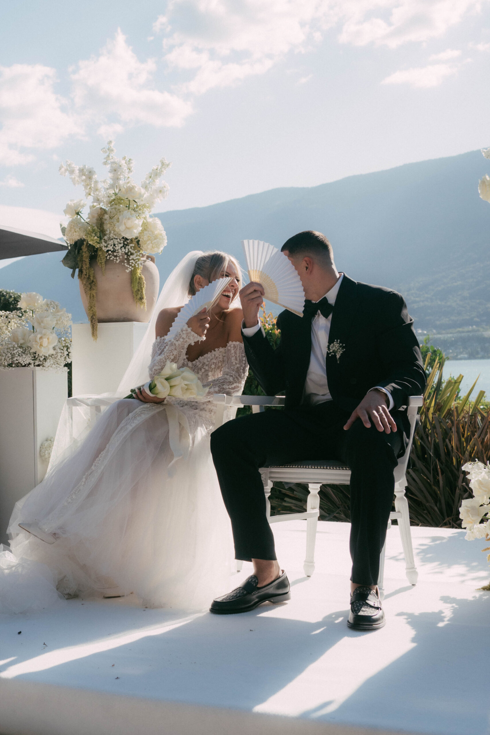 couple laughing during their ceremony by the lake in the French alps