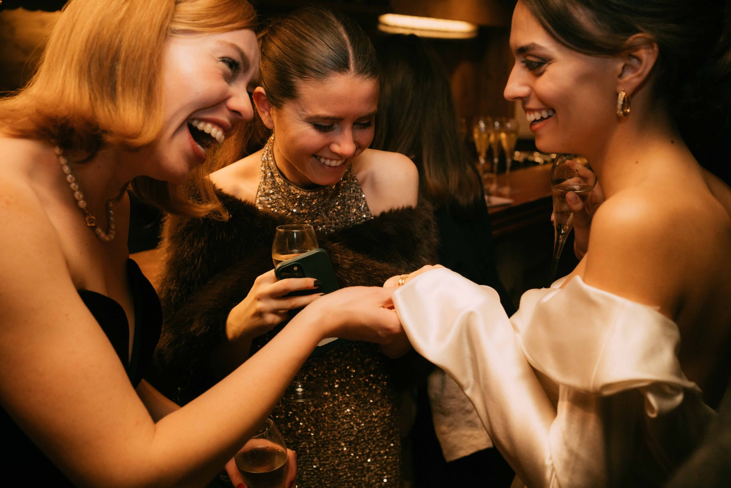 bride and friends during cocktail, they are looking at the ring